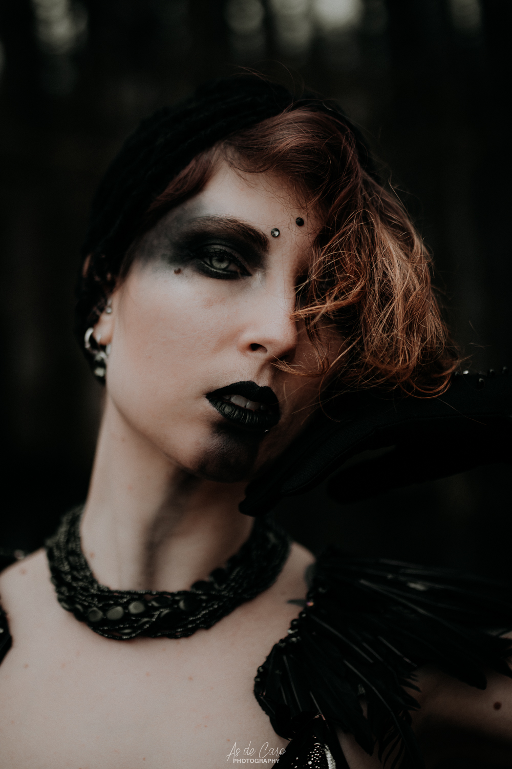 Portrait artistique dark d'une femme avec un maquillage noir et des plumes à Lyon